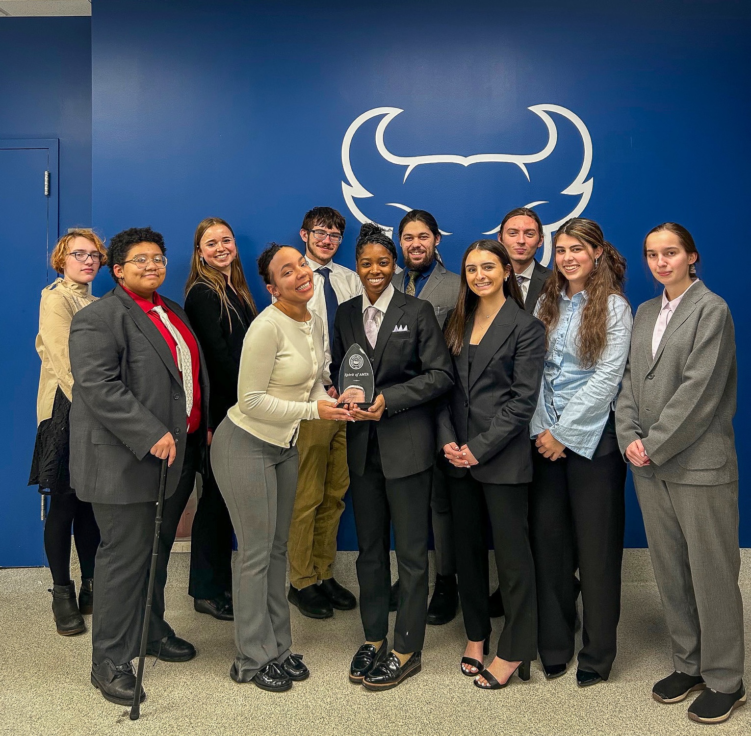 Group of student standing, holding an award
